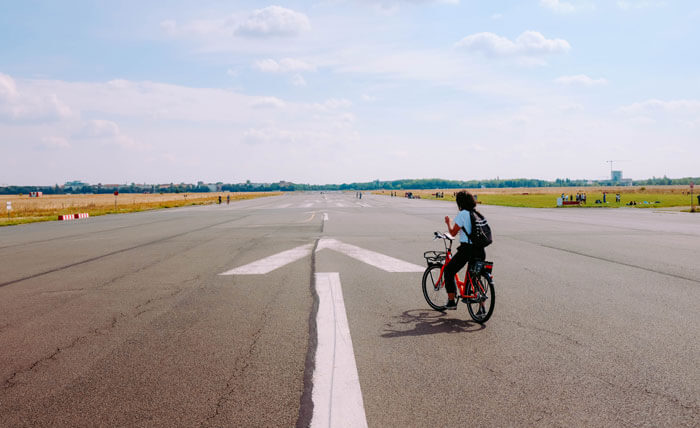 a person riding a cycle stopped on the road