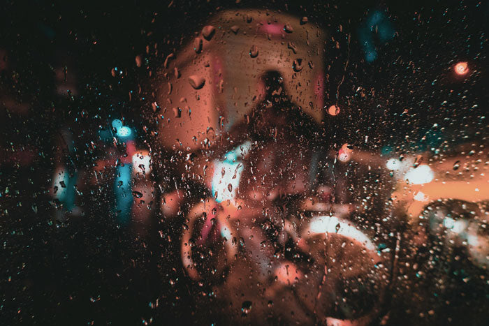 a person riding a bike in the rain