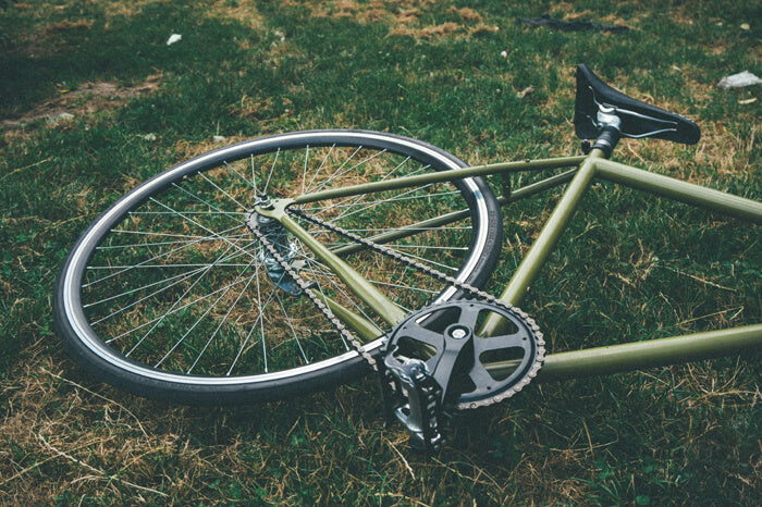 a green bicycle down on the green grass