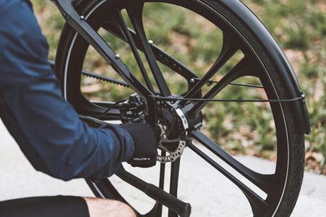a person checking the hub motor and wheel of an e bike