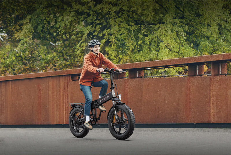 a woman rides an engwe ep-2 pro e-bike on the road