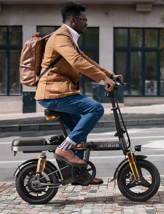 a man rides an electric mini bike engwe t14 on the road