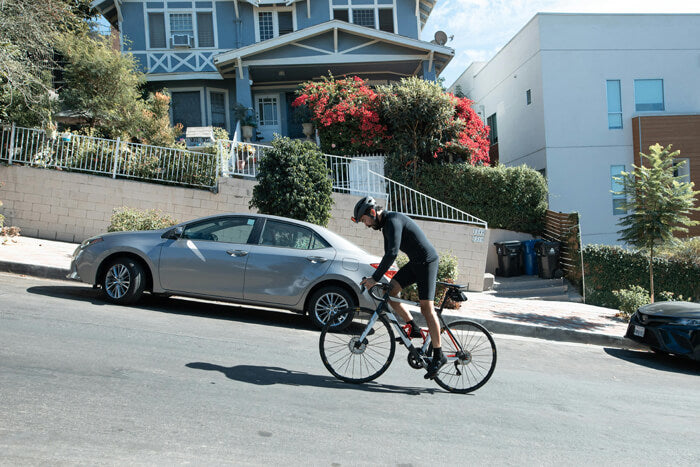 a man rides a bicycle uphill