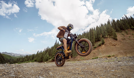 a man rides an engwe m20 2.0 moped-style e-bike on the sand
