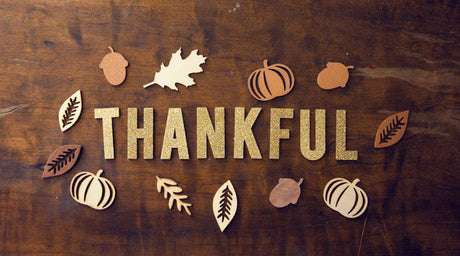 a "thankful" on the brown wooden board