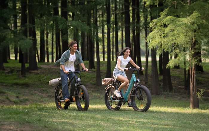 a man riding a step over engwe e26 and a woman riding a engwe e26 step through e bike on the grass