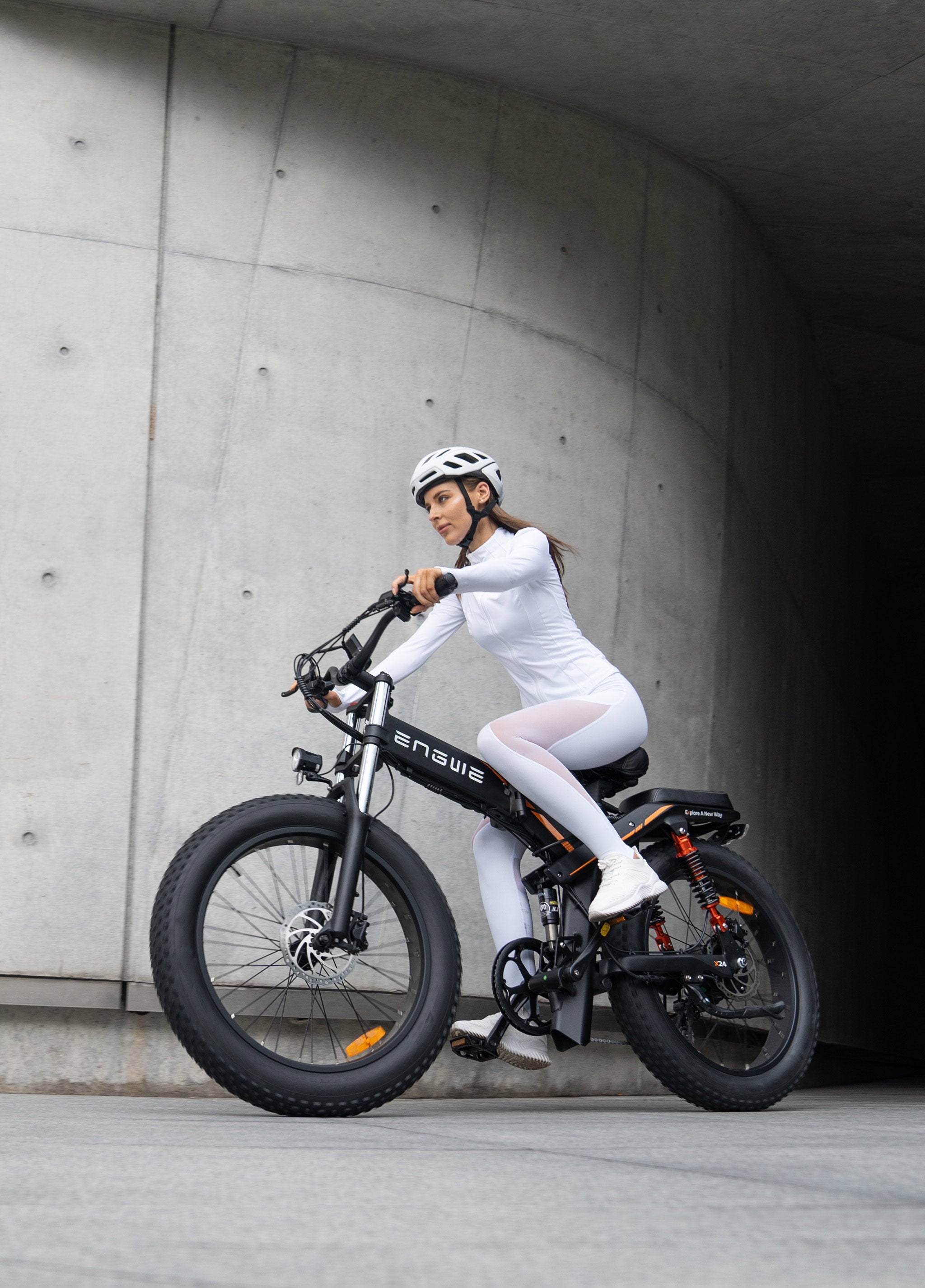 a girl rides a black engwe x24 folding e-bike