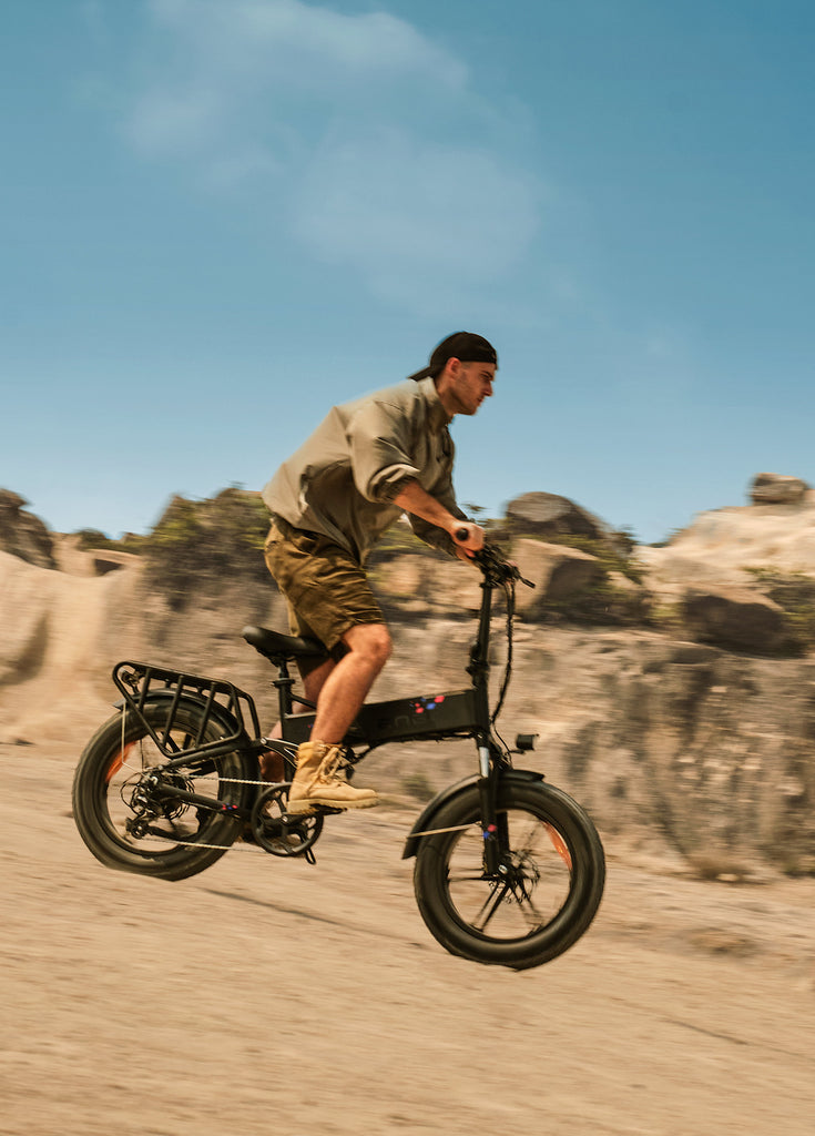 a man rides an engwe engine pro electric bike on the sand