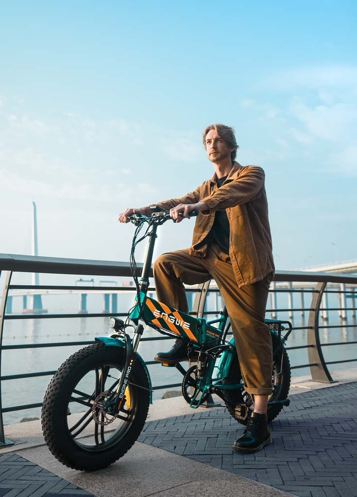 a man sits on a green engine pro electric bike